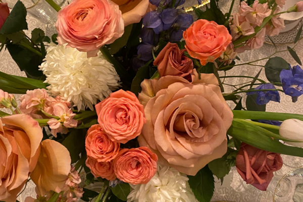 An ariel view of a bouquet of flowers. Beautiful pink, purple, and white flowers sit atop a decorated wedding table.