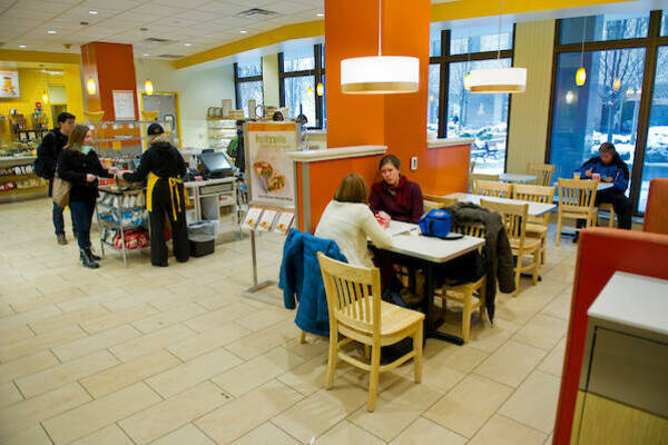 Interior of Au Bon Pain Café with students working at tables