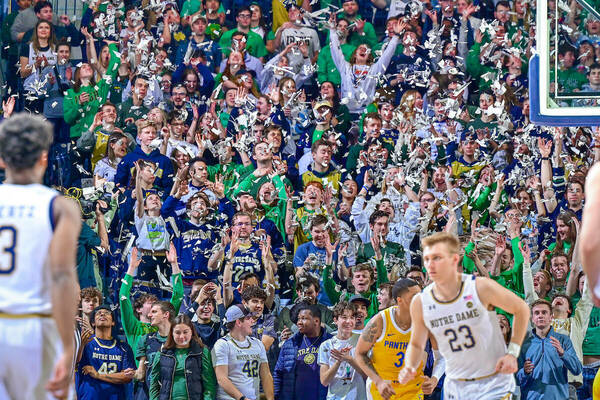 Notre Dame Men's Basketball player running back on defense with a cheering crowd behind him