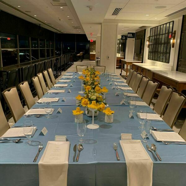Seven on 9 event space decorated for an event. The space includes a light blue tablecloth and white place settings.
