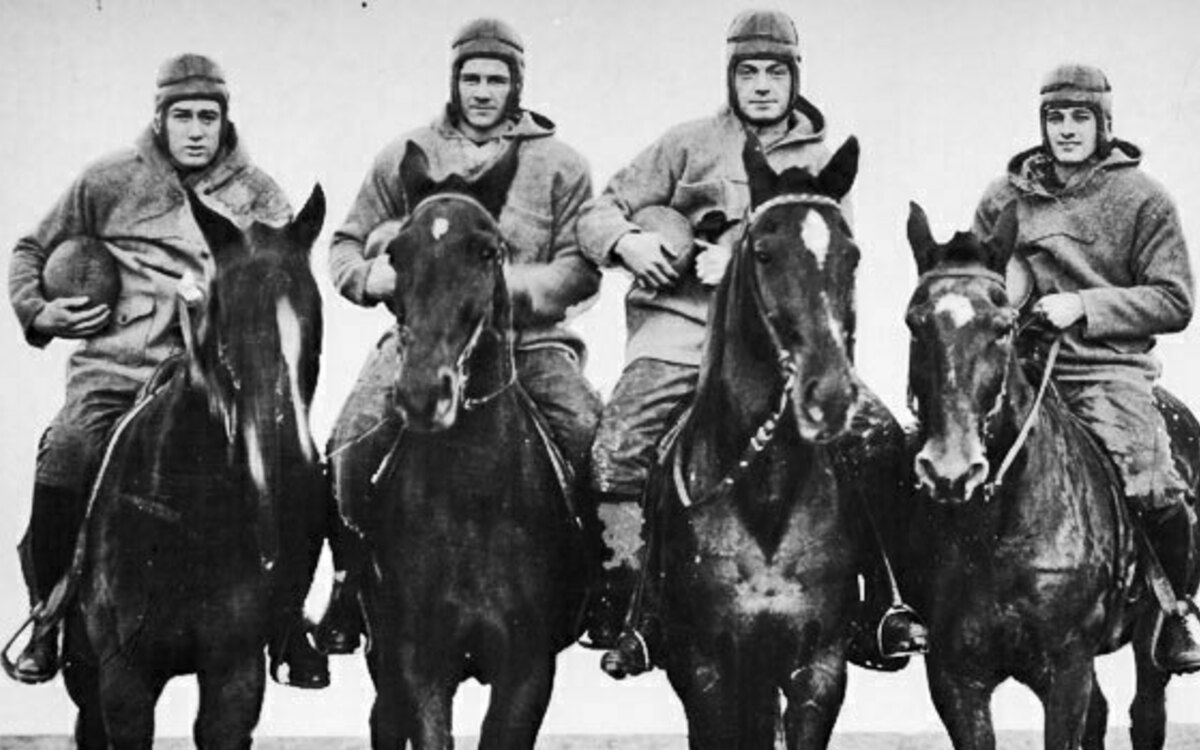 Black and white photo of the four horsemen. It was 77 years ago that a dramatic nickname coined by a poetic sportswriter and the quick-thinking actions of a clever student publicity aide transformed the Notre Dame backfield of Stuhldreher, Crowley, Miller and Layden into the most fabled quartet in college football history.