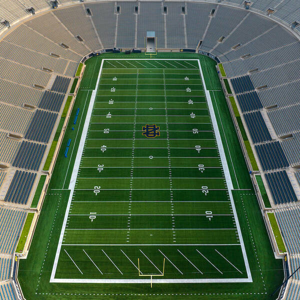 Ariel view of the football field. Stadium seats line the sides and a big painted ND can be seen in the middle of the field.