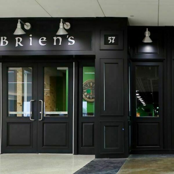Dark wood creates an entrance to O'Brien's. Lights and front doors give this venue space a restaurant feel.