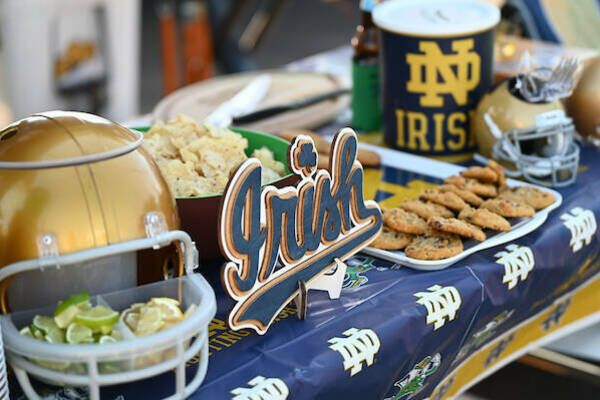 Tailgating with gold helmet, Irish sign and cookies