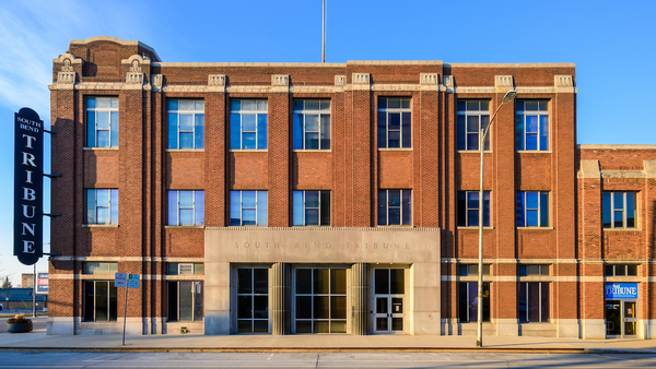 Facade of brick newspaper building.