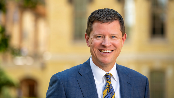 A man in a blue suit and striped tie.