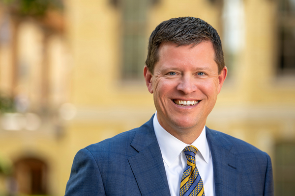 A man in a blue suit and striped tie.